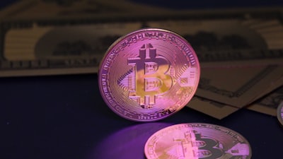 Bitcoin coin and us dollar bills.