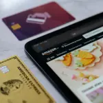a smart phone sitting next to a credit card